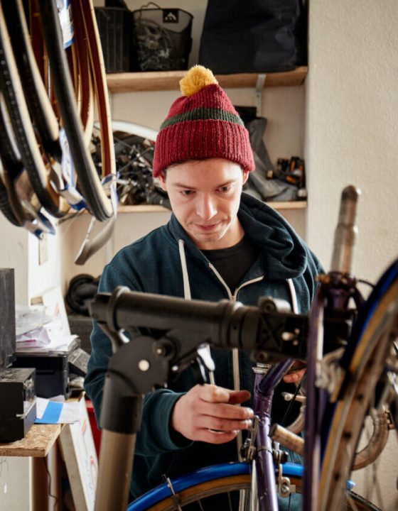 a-young-man-working-in-a-cycle-shop-repairing-a-b-2022-03-04-02-20-22-utc-e1697778987999.jpg